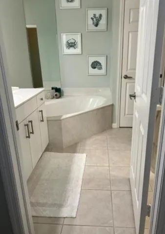 a bathroom with a bathtub sink and vanity