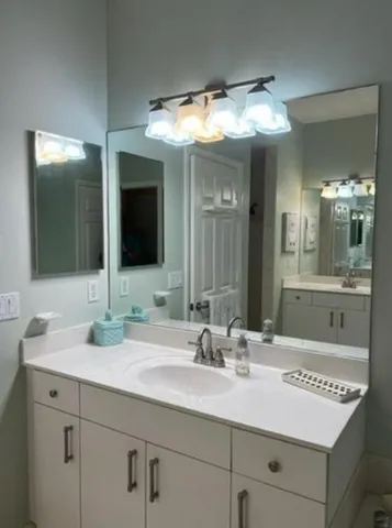 a bathroom with a sink and a mirror