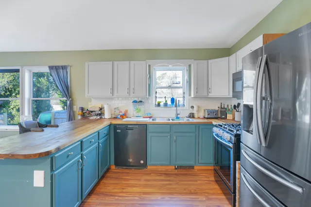 a kitchen with stainless steel appliances granite countertop a refrigerator sink and cabinets