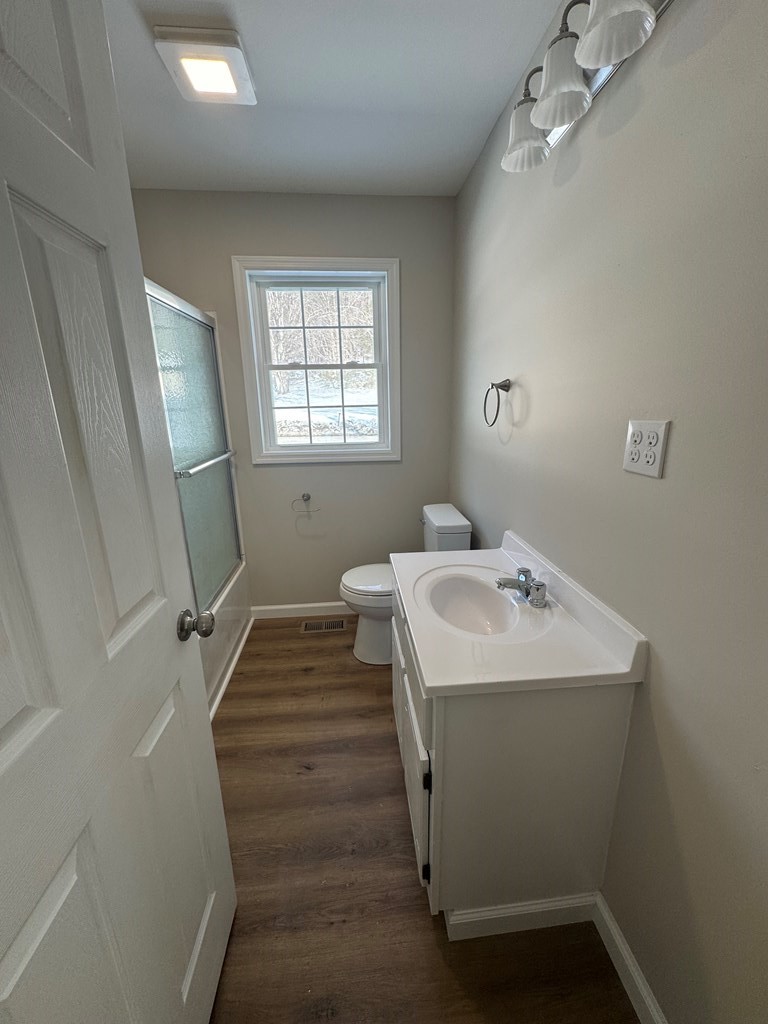 1106 East Railroad Street Waverly, TN 37185 - Photo 12 of 21 a bathroom with a sink toilet and a window