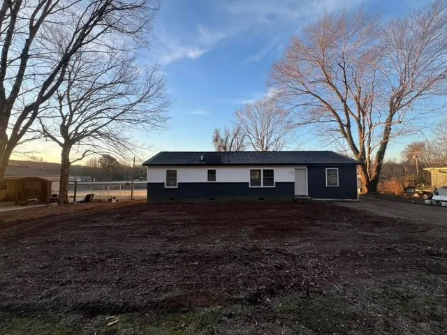 a house that has a tree in front of it