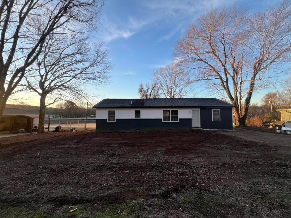 1106 East Railroad Street Waverly, TN 37185 - Photo 4 of 21 a house that has a tree in front of it