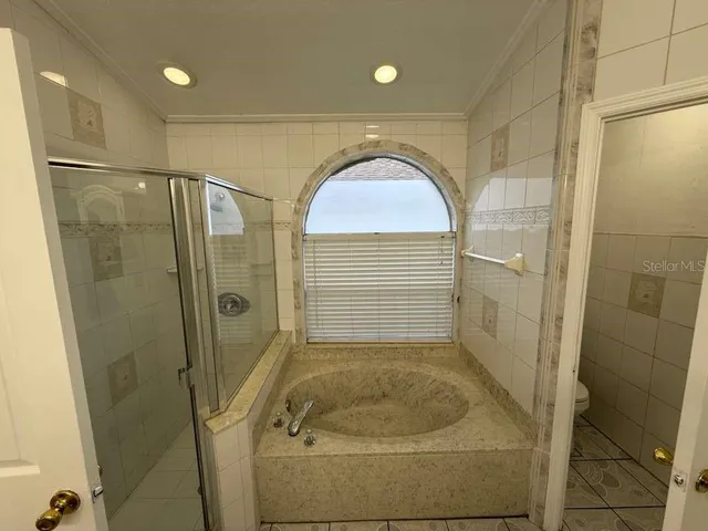 a bathroom with a granite countertop shower and a sink