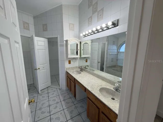 a bathroom with a sink double vanity and a mirror