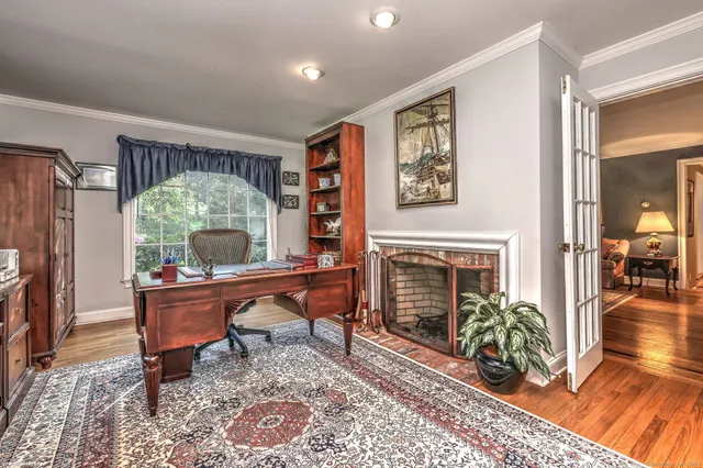 a living room with furniture a fireplace and a table