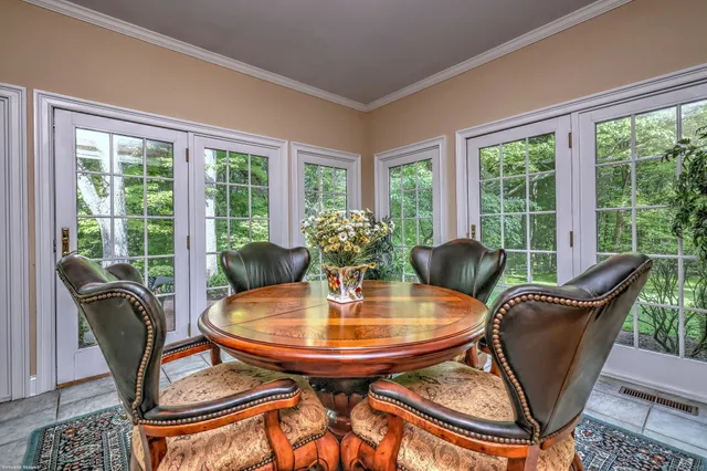 a dining room with furniture wooden floor and a potted plant