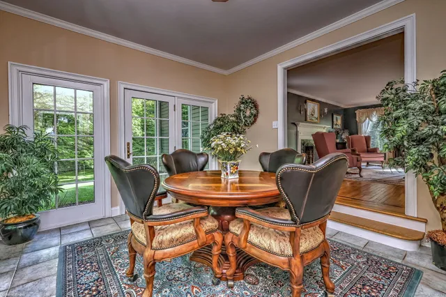 a dining room with furniture and wooden floor