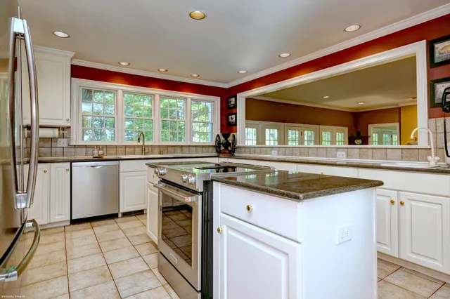 a kitchen with stainless steel appliances granite countertop a sink and cabinets