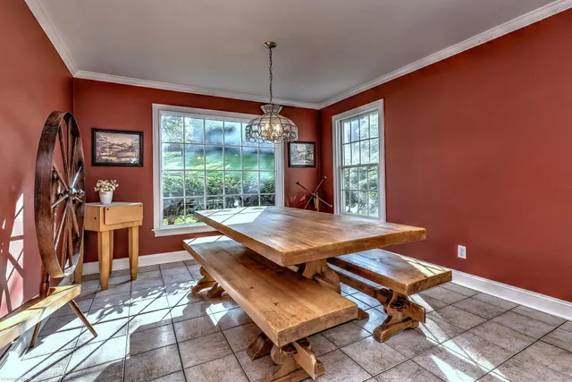 a room with pool table and windows