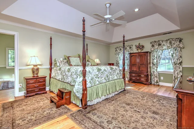 a bedroom with a bed window and dresser