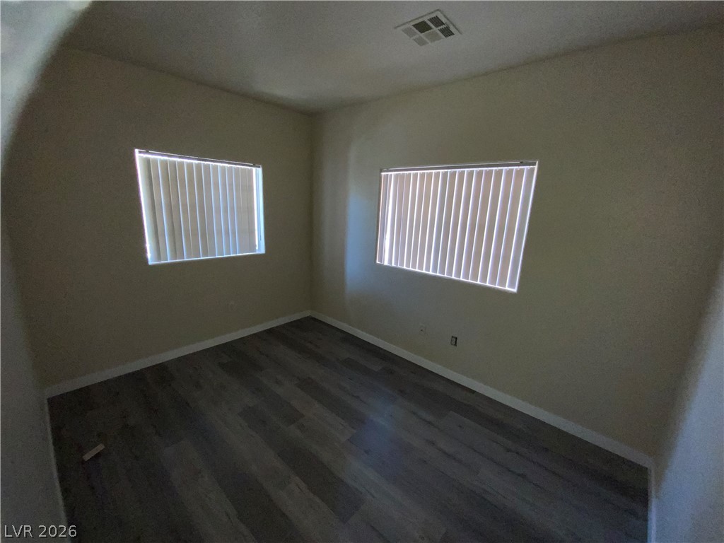 4730 East Craig Road, Unit 1154 Las Vegas, NV 89115 - Photo 9 of 13 Hardwood-style flooring and natural illumination define this versatile secondary bedroom space.