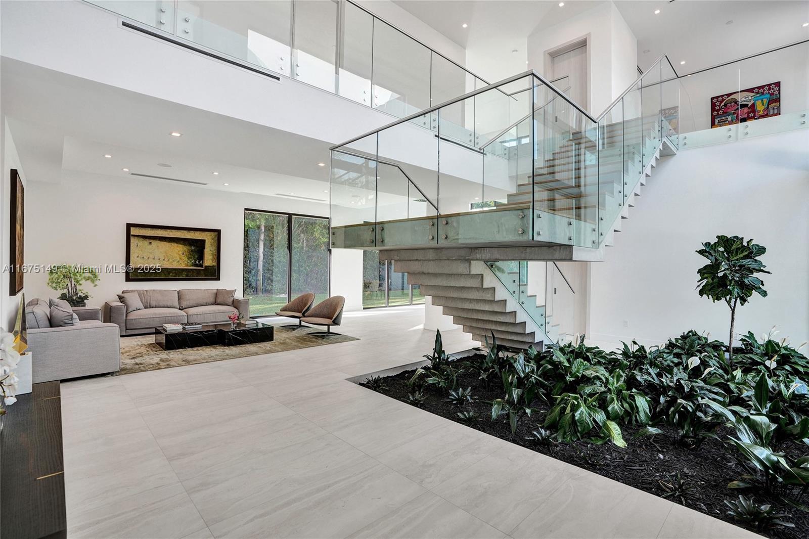 6350 Southwest 112th Street Pinecrest, FL 33156 - Photo 17 of 88 a room with lots of flower plants and wooden floor