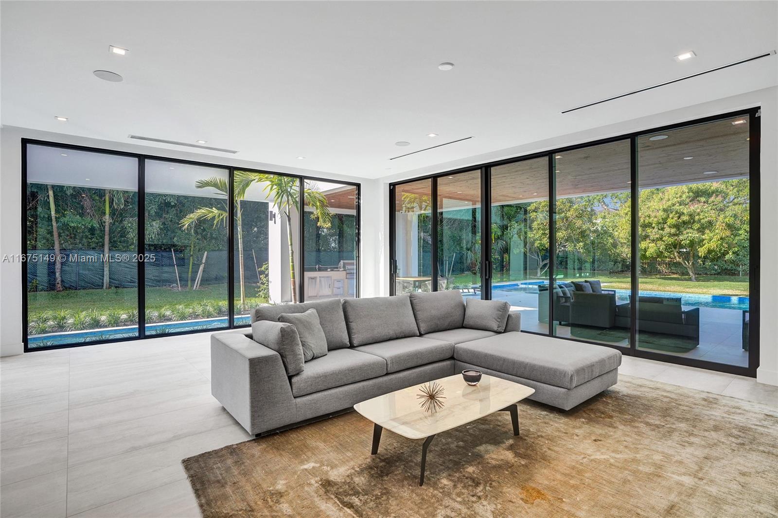 6350 Southwest 112th Street Pinecrest, FL 33156 - Photo 27 of 88 a living room with furniture and a large window