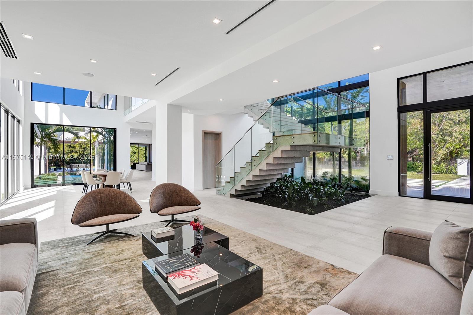 6350 Southwest 112th Street Pinecrest, FL 33156 - Photo 3 of 88 a living room with furniture and floor to ceiling windows