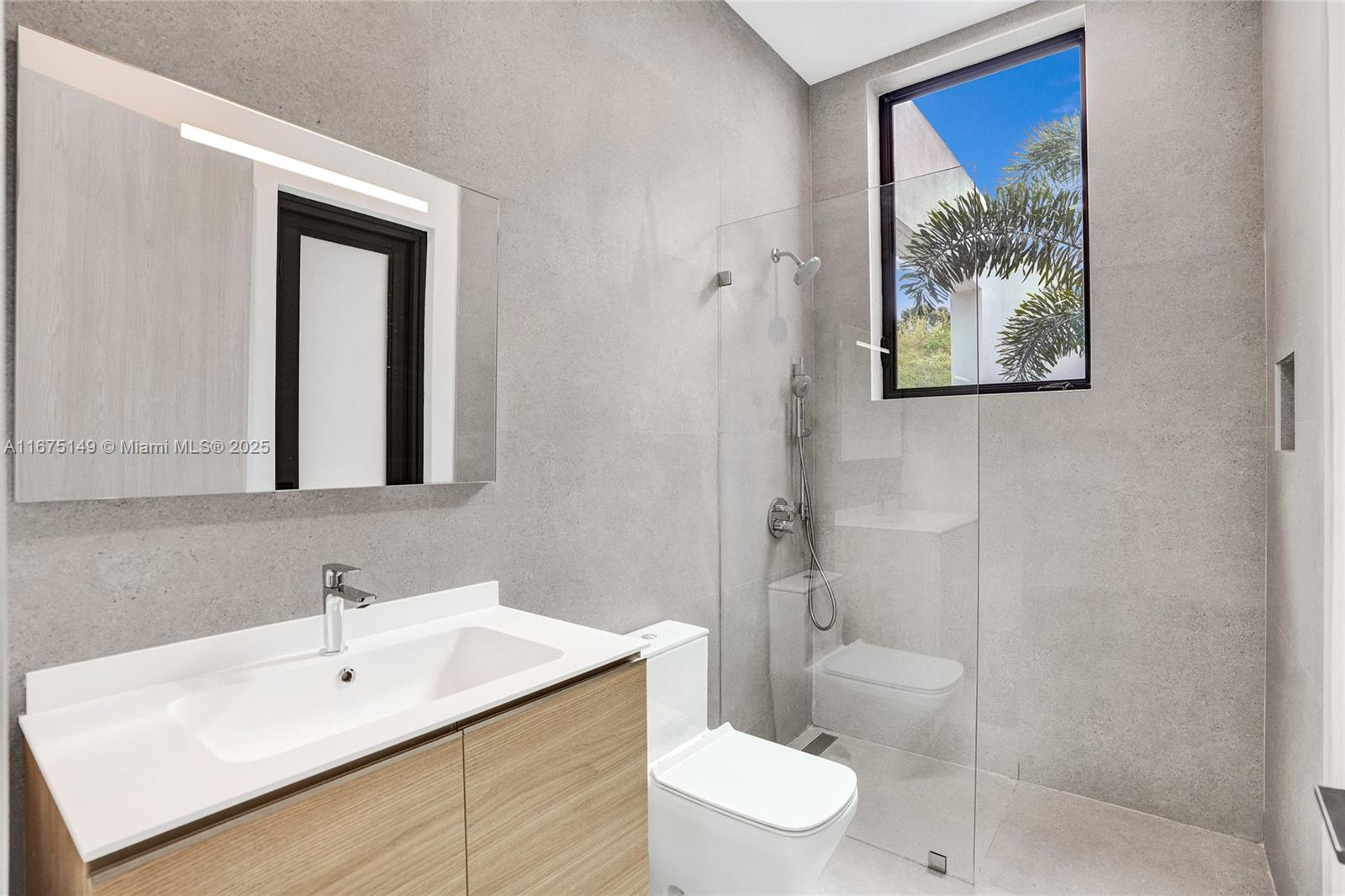 6350 Southwest 112th Street Pinecrest, FL 33156 - Photo 37 of 88 a bathroom with a toilet sink and mirror