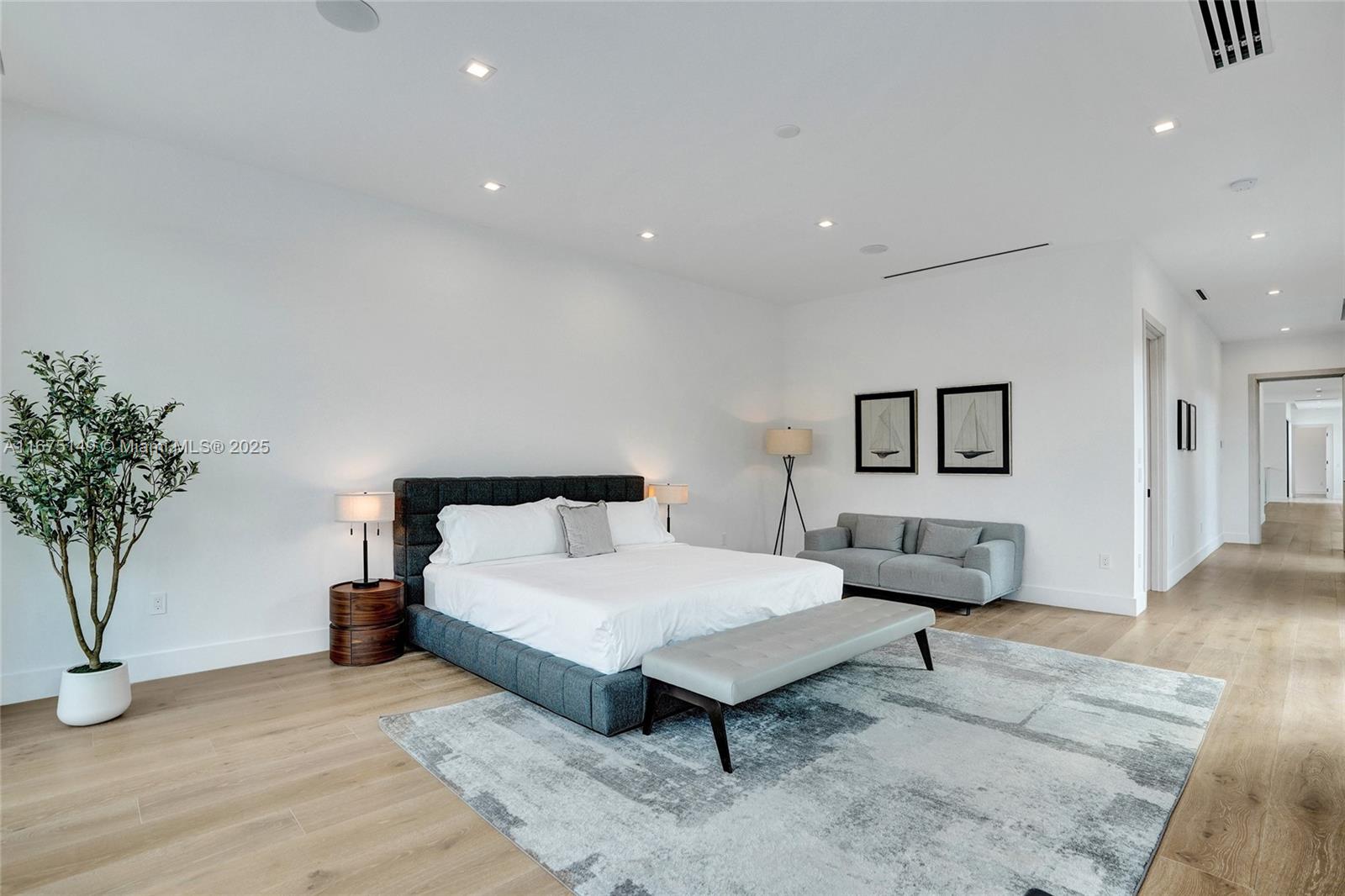 6350 Southwest 112th Street Pinecrest, FL 33156 - Photo 46 of 88 a spacious bedroom with a bed and a potted plant