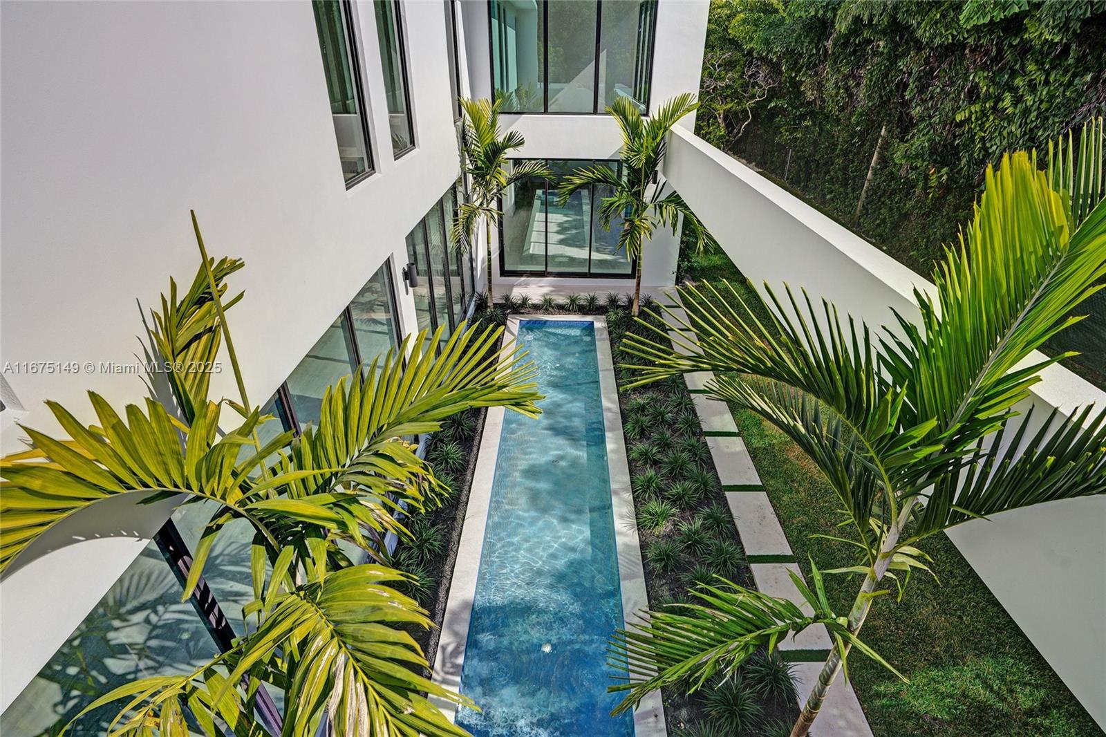 6350 Southwest 112th Street Pinecrest, FL 33156 - Photo 53 of 88 a view of a palm plant that is in front of house