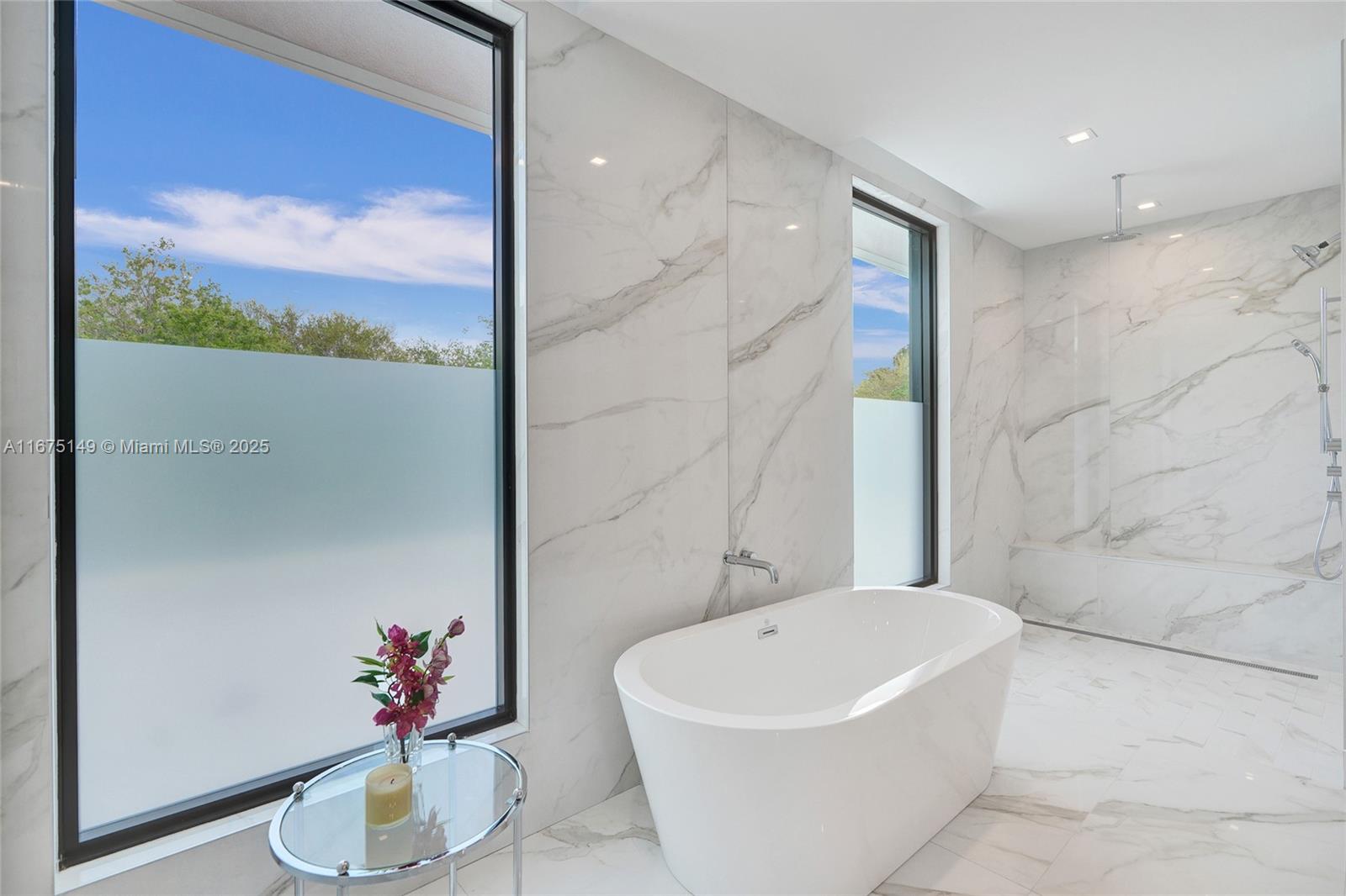 6350 Southwest 112th Street Pinecrest, FL 33156 - Photo 56 of 88 a bathroom with a bathtub and a potted plant