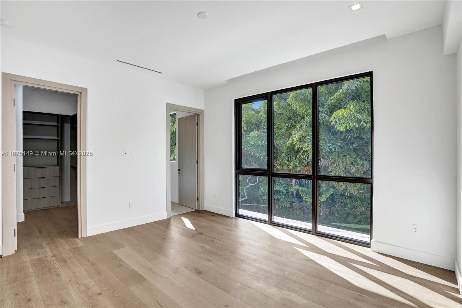 6350 Southwest 112th Street Pinecrest, FL 33156 - Photo 67 of 88 an empty room with wooden floor and windows