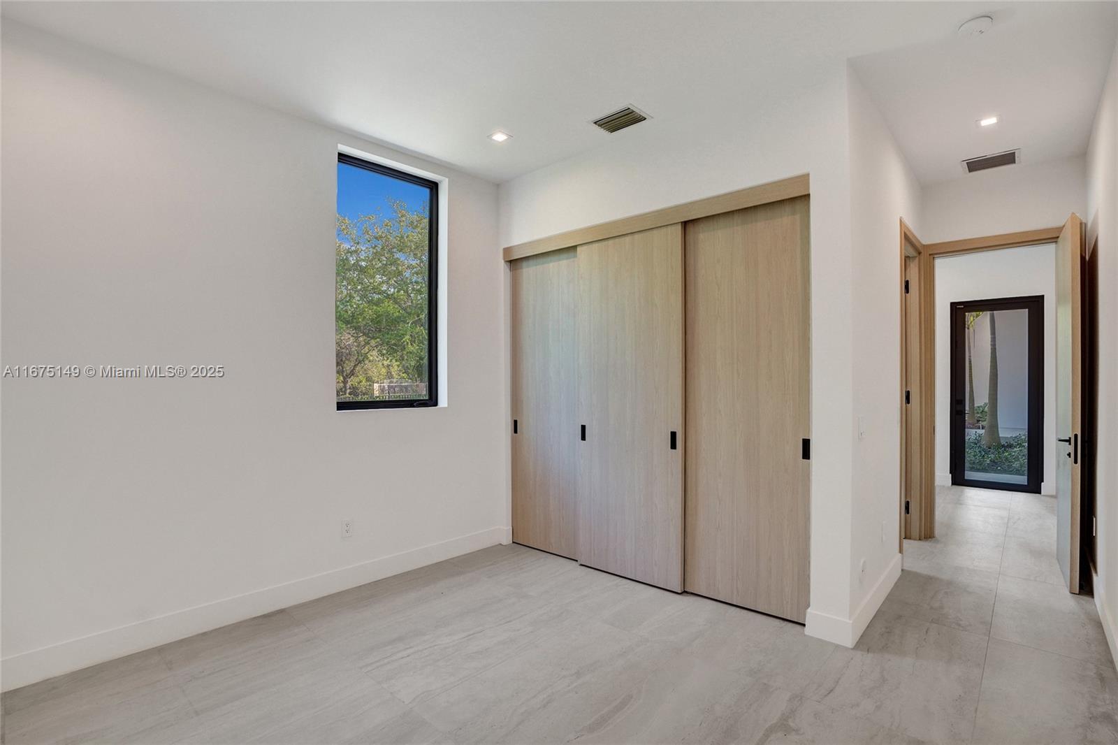 6350 Southwest 112th Street Pinecrest, FL 33156 - Photo 77 of 88 a view of an empty room with closet and a window