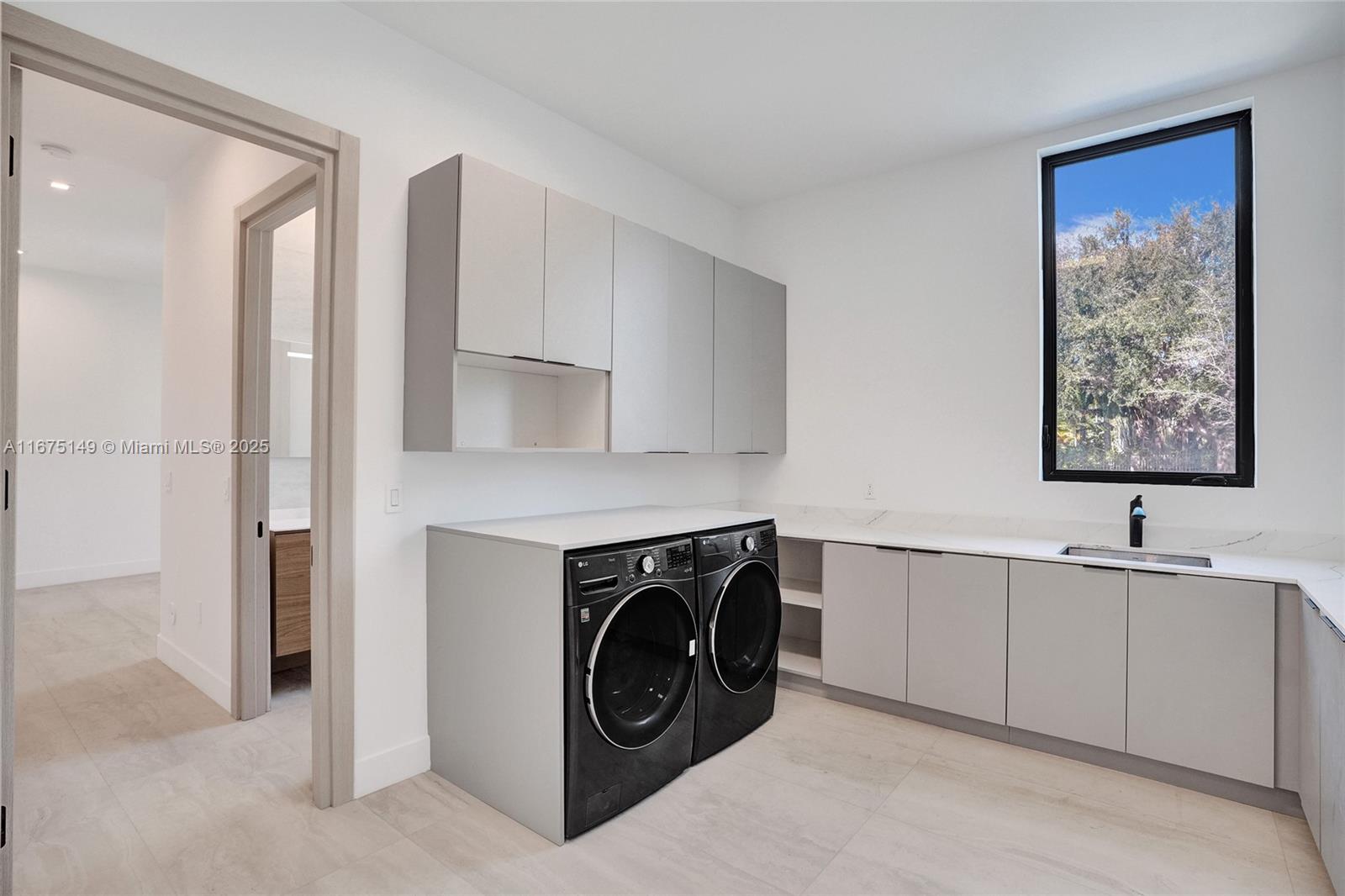 6350 Southwest 112th Street Pinecrest, FL 33156 - Photo 79 of 88 a utility room with sink dryer and washer