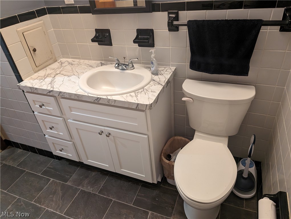 30213 Barjode Road Willowick, OH 44095 - Photo 5 of 20 Bathroom featuring tile flooring, vanity, and tile walls
