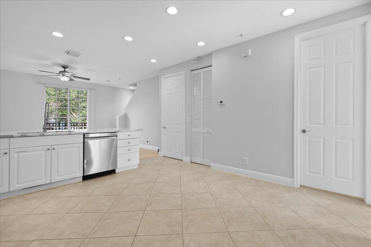 802 University Boulevard Jupiter, FL 33458 - Photo 14 of 40 a view of a kitchen with refrigerator and white cabinets