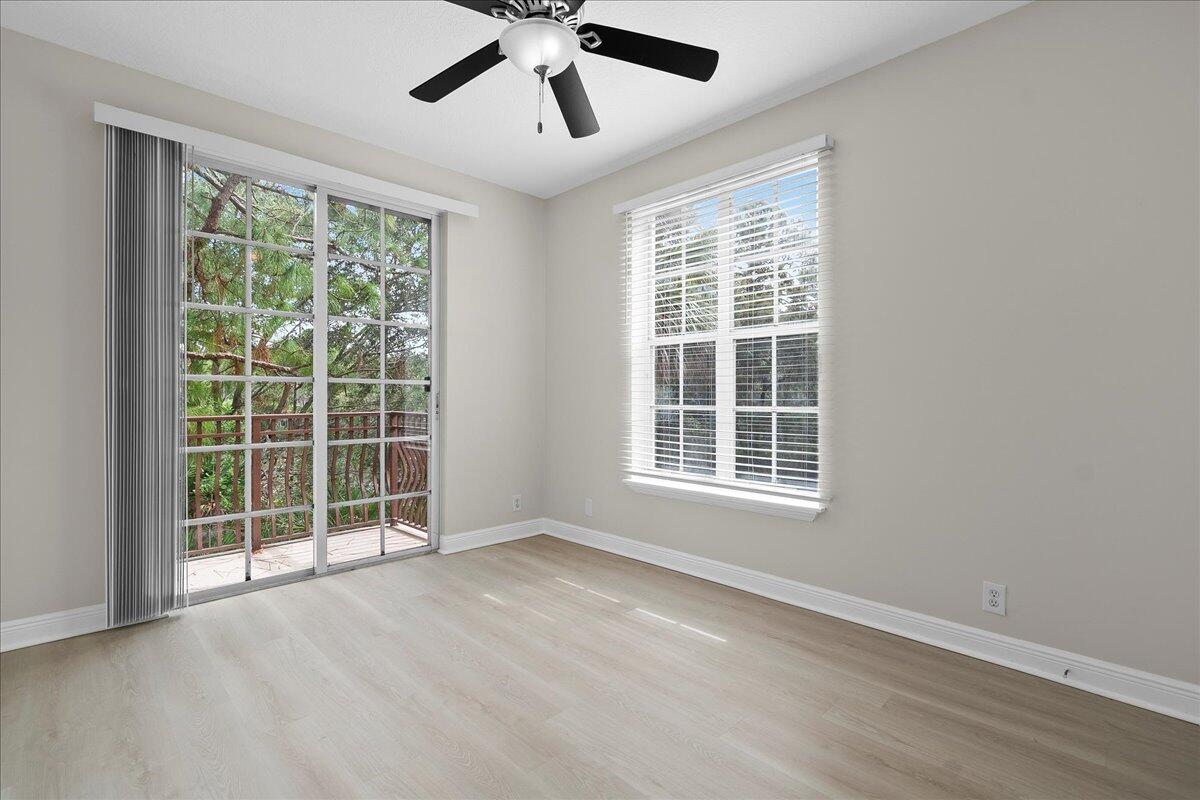 802 University Boulevard Jupiter, FL 33458 - Photo 16 of 40 a view of an empty room with a window and wooden floor