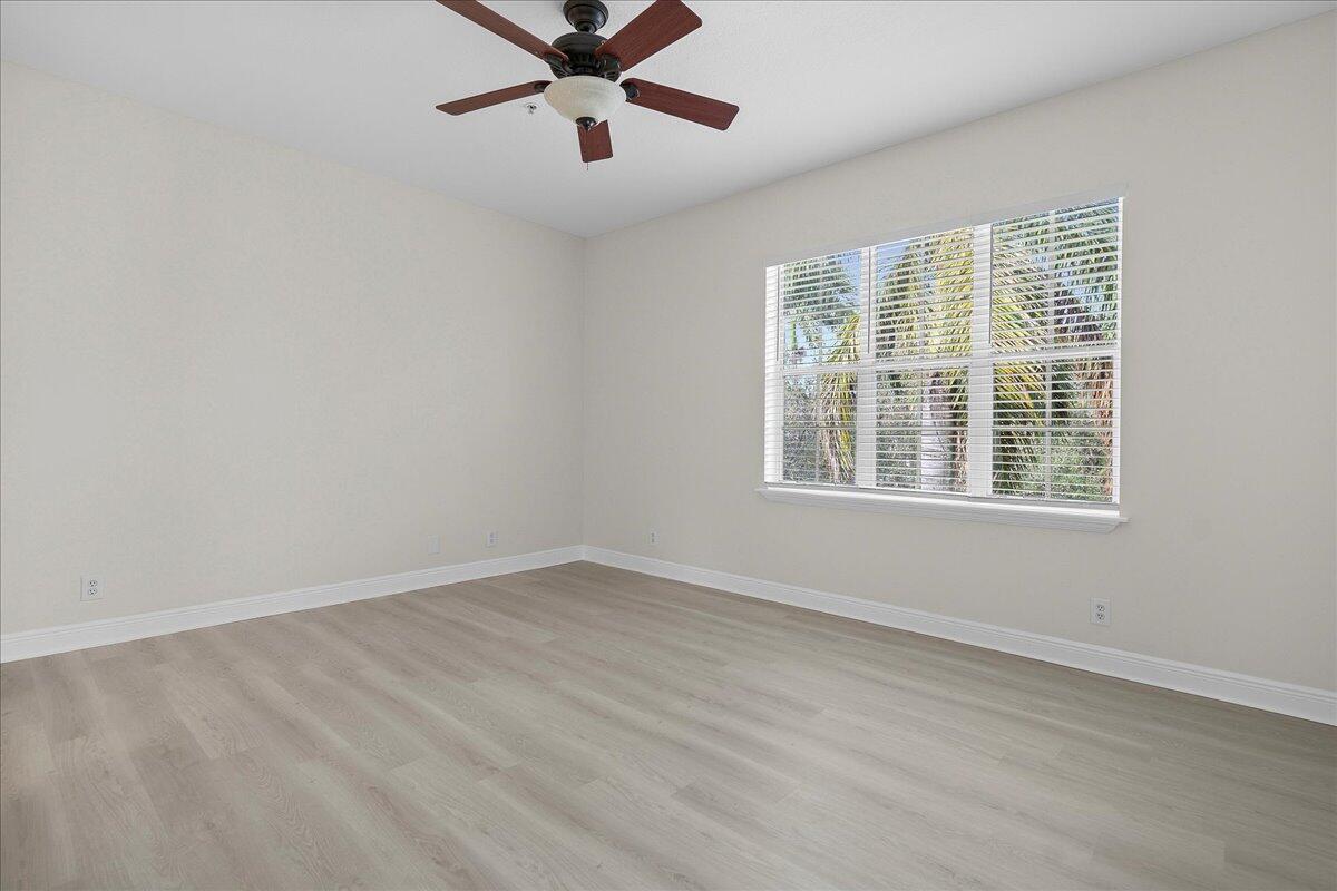 802 University Boulevard Jupiter, FL 33458 - Photo 20 of 40 an empty room with a window and a fan