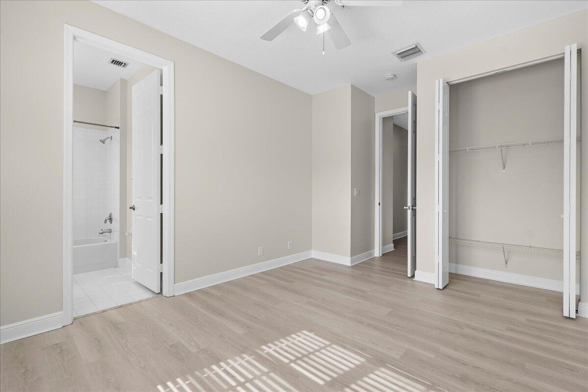 802 University Boulevard Jupiter, FL 33458 - Photo 27 of 40 an empty room with wooden floor and closet area
