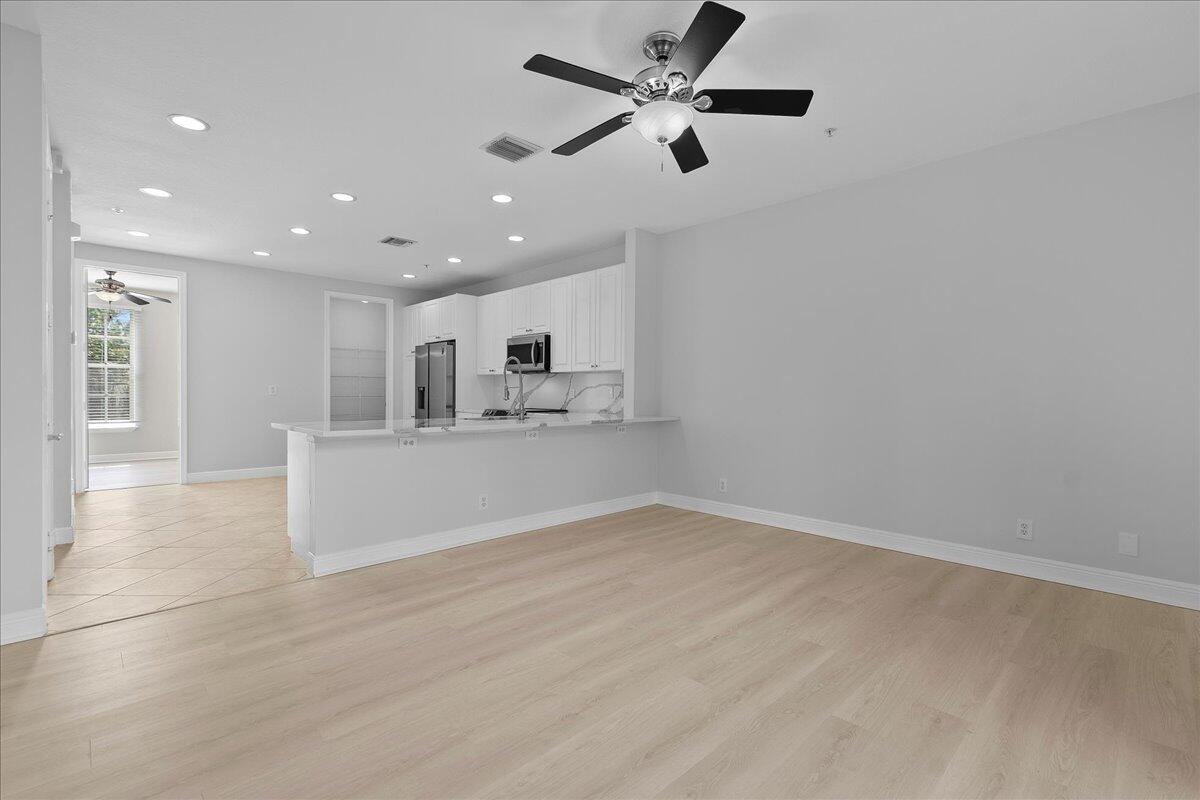 802 University Boulevard Jupiter, FL 33458 - Photo 9 of 40 a view of a kitchen with a sink and a refrigerator