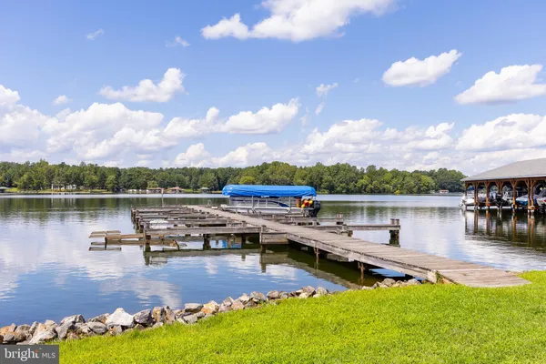 a view of a lake with boats and trees in the background