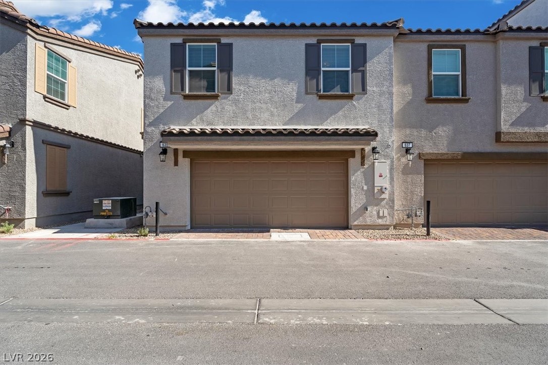 635 Bellus Place Henderson, NV 89015 - Photo 6 of 37 View of front facade with a garage, stucco siding, driveway, and a tiled roof