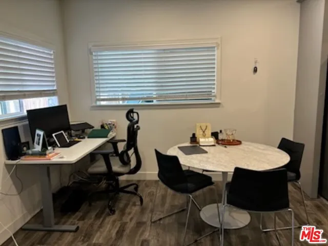a view of a dining room with a table and chairs