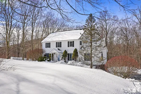a view of a house with snow on the road
