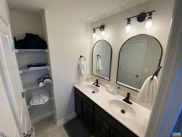 a bathroom with a double vanity sink and mirror
