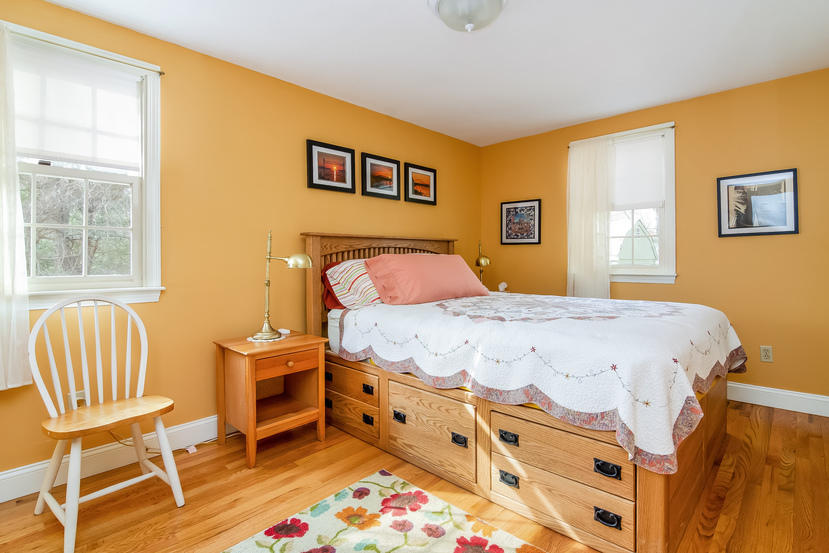 24 Stephen Road Bourne, MA 02532 - Photo 12 of 20 a bedroom with a bed and a chair