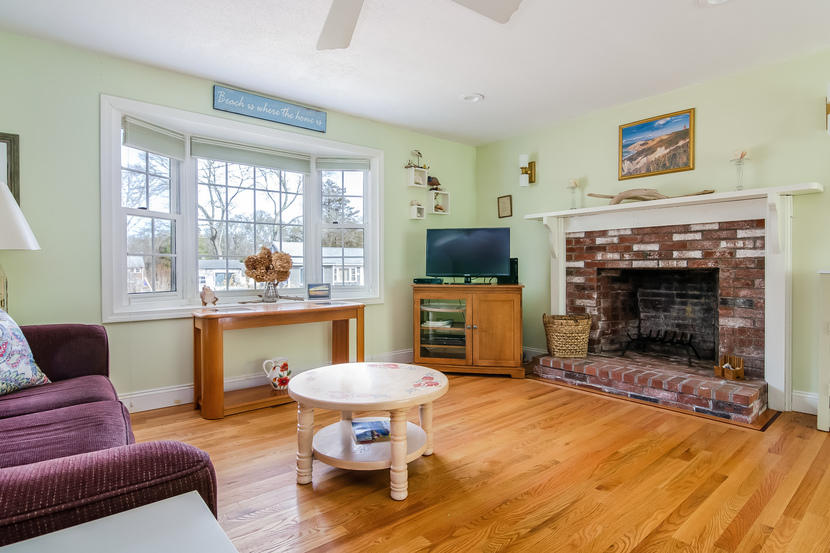 24 Stephen Road Bourne, MA 02532 - Photo 3 of 20 a living room with furniture a flat screen tv and a fireplace