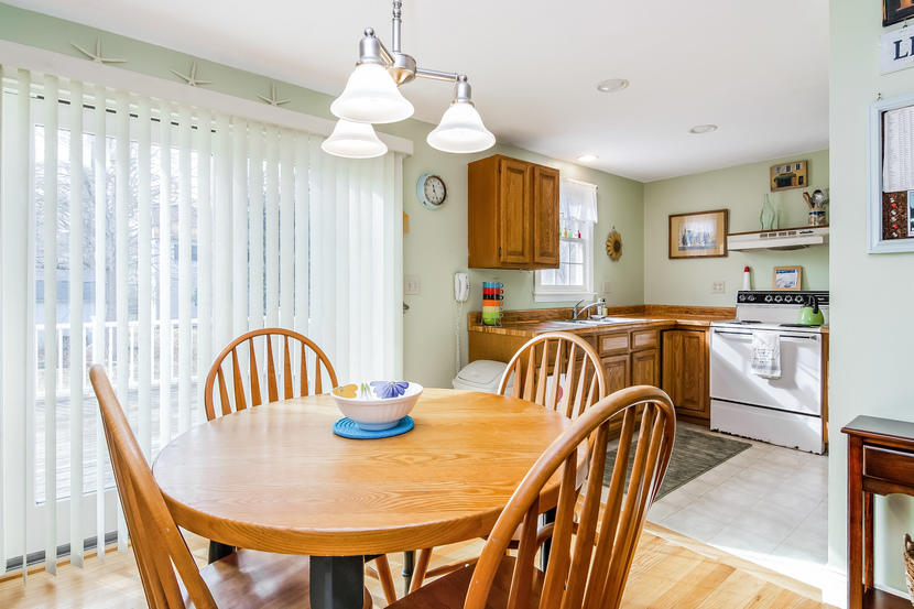 24 Stephen Road Bourne, MA 02532 - Photo 7 of 20 a view of a dining room and a kitchen with furniture window and wooden floor