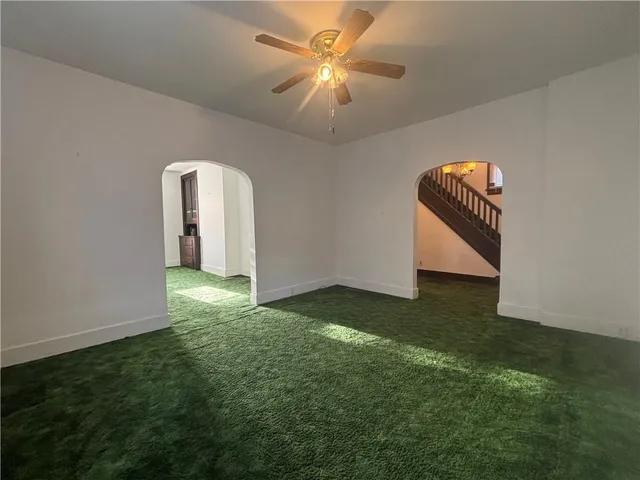 a view of a big room with closet and a chandelier fan
