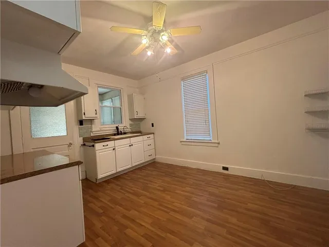 a kitchen with granite countertop white cabinets and stainless steel appliances