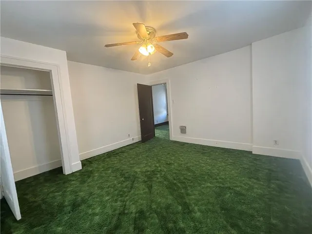 a view of room with window and a ceiling fan