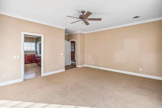 a view of an empty room with a ceiling fan