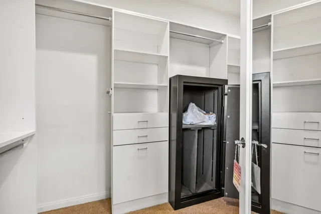 a view of a hallway with wooden floor and entryway