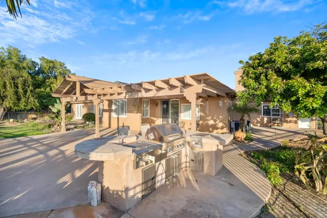 a view of a patio with couches table and chairs and potted plants