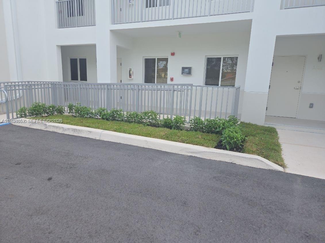 310 East 7th Street, Unit 203 Hialeah, FL 33010 - Photo 2 of 13 front view of a house with a yard