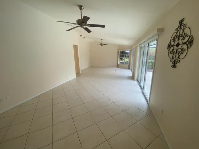 a view of a livingroom with a ceiling fan and window