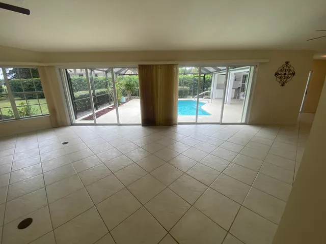 a view of an empty room and a window