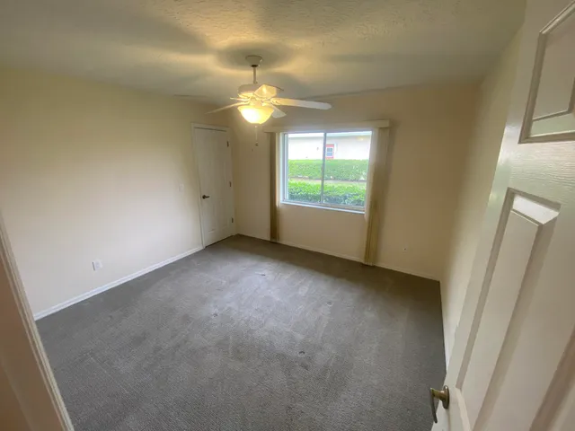 an empty room with windows and outdoor view