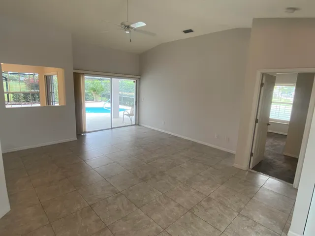 an empty room with large windows